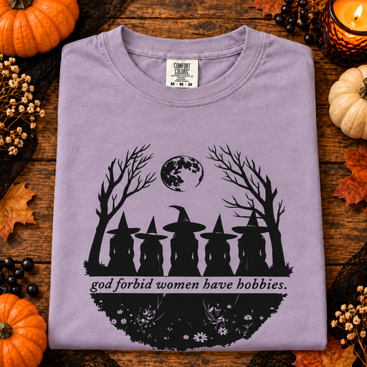 Folded dusty lavender God Forbid Women Have Hobbies T-shirt with Halloween pumpkins