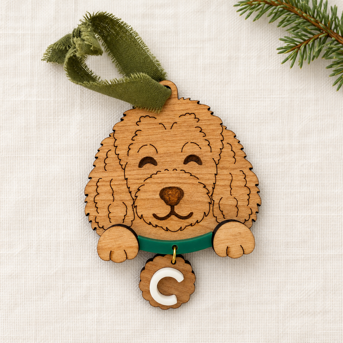 Wooden doodle dog ornament with green collar and personalized C initial tag